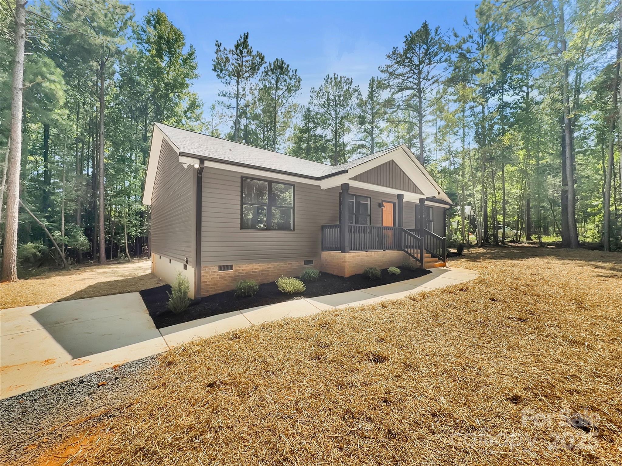 2330 Neill Road Lancaster, SC 29720 - Photo 2 of 39 a front view of a house with a yard and trees