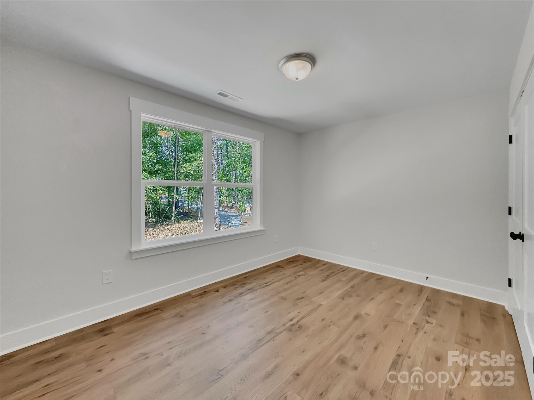 2330 Neill Road Lancaster, SC 29720 - Photo 26 of 39 an empty room with wooden floor and windows