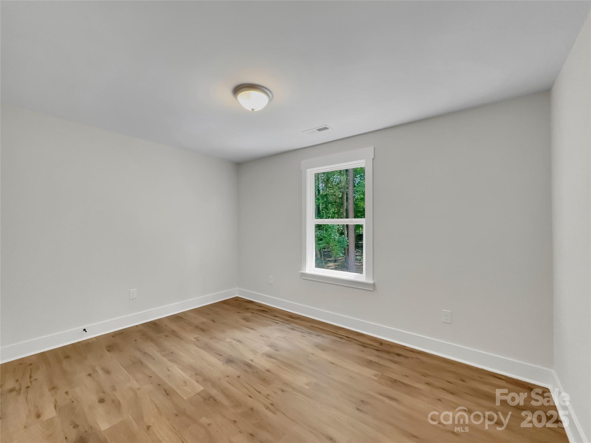 2330 Neill Road Lancaster, SC 29720 - Photo 29 of 39 an empty room with wooden floor and windows