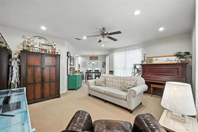 a living room with furniture a chandelier and a fireplace