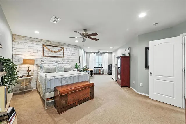 a living room with furniture and a refrigerator