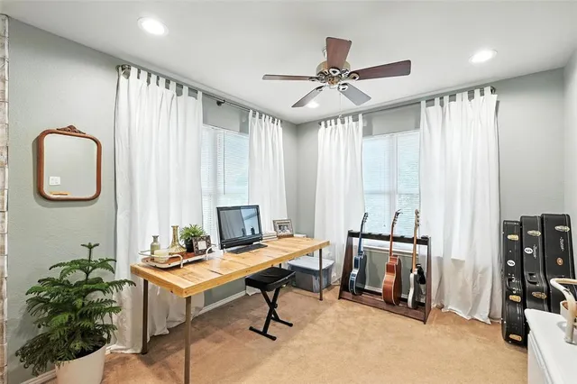 a view of a livingroom with workspace and a window