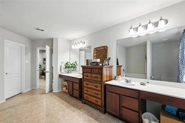 a bathroom with a double vanity sink and a mirror