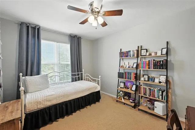 a bedroom with a bed furniture and a book shelf