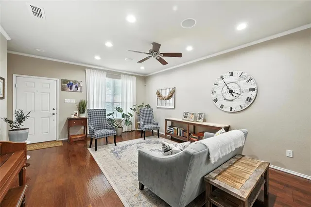 a living room with furniture and wooden floor