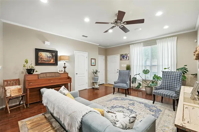 a living room with furniture and wooden floor