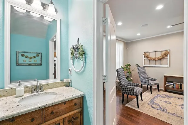 a en suite bathroom with a granite countertop sink and a mirror