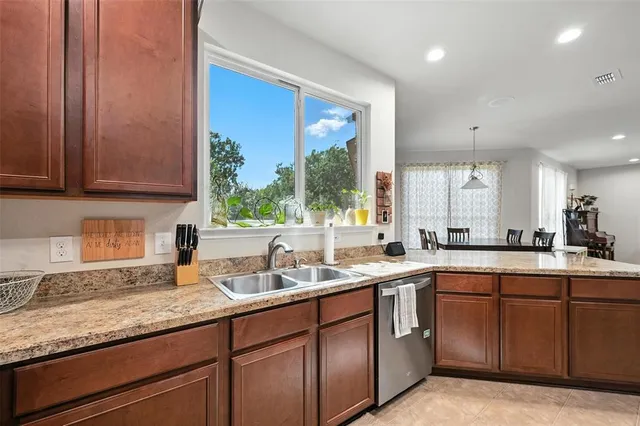 a kitchen with a sink cabinets and window