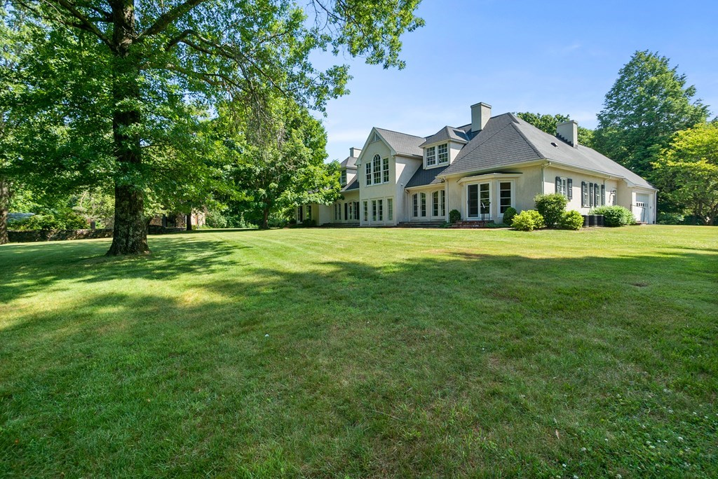 1 Rocky Ridge Road Dedham, MA 02026 - Photo 31 of 38 a front view of a house with a yard