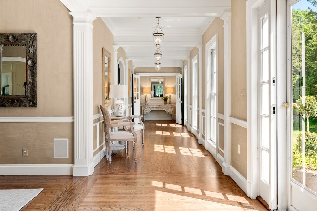1 Rocky Ridge Road Dedham, MA 02026 - Photo 4 of 38 a hallway with wooden floor chandelier and livingroom