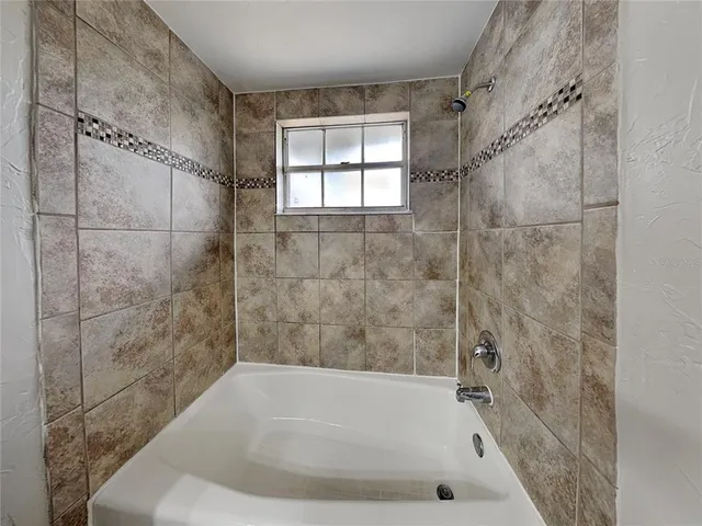 a bath tub sitting in a bathroom next to a window