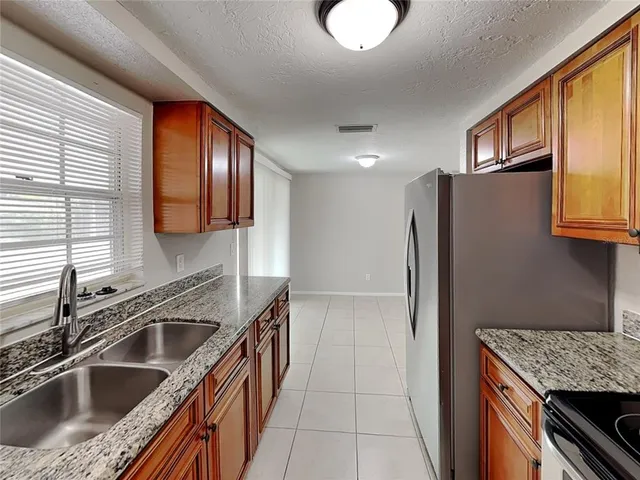 a kitchen that has a sink cabinets counter space and stainless steel appliances