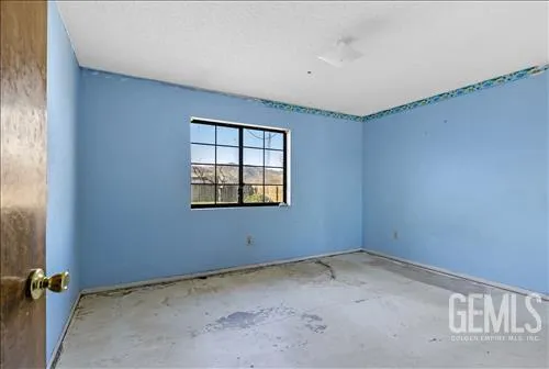 a view of a livingroom with a ceiling fan and window