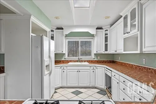a kitchen with a sink stove and cabinets