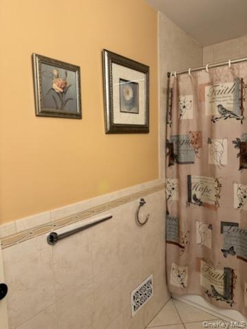 23 Notingham Circle, Unit 23 Peekskill, NY 10566 - Photo 8 of 12 Bathroom with a shower with shower curtain, tile patterned floors, and wainscoting