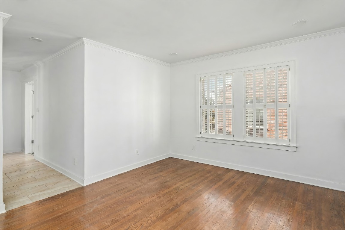 1740 Wroxton Court Houston, TX 77005 - Photo 16 of 27 an empty room with wooden floor and windows