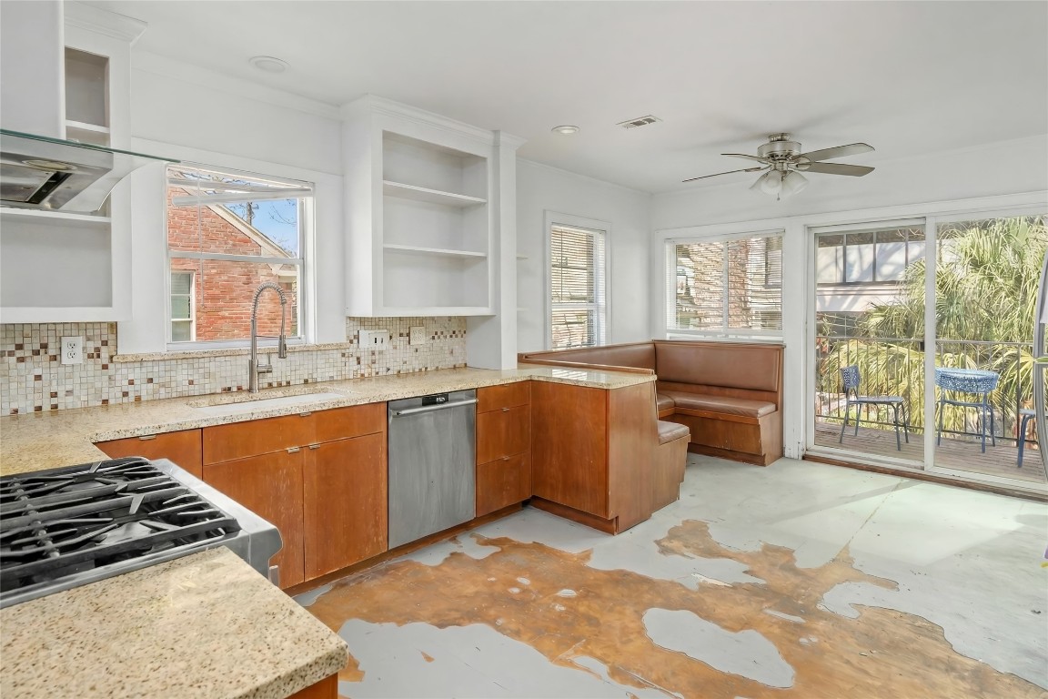 1740 Wroxton Court Houston, TX 77005 - Photo 19 of 27 a kitchen with a stove a sink and a refrigerator