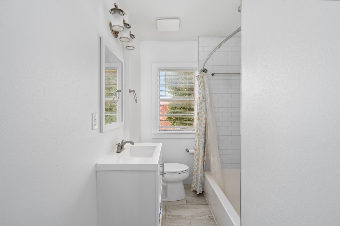 1740 Wroxton Court Houston, TX 77005 - Photo 23 of 27 a bathroom with a sink a toilet and shower