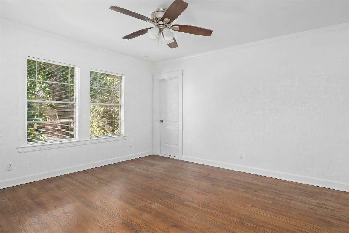 1740 Wroxton Court Houston, TX 77005 - Photo 24 of 27 an empty room with wooden floor fan and windows