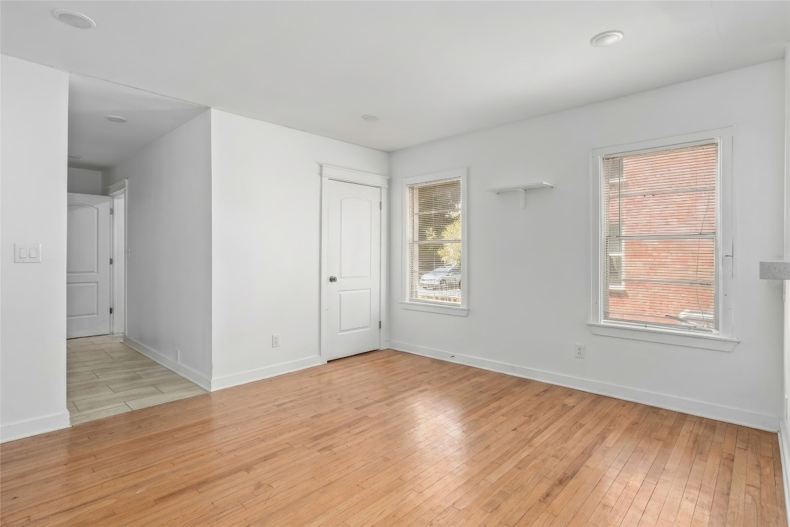 1740 Wroxton Court Houston, TX 77005 - Photo 3 of 27 an empty room with wooden floor and windows