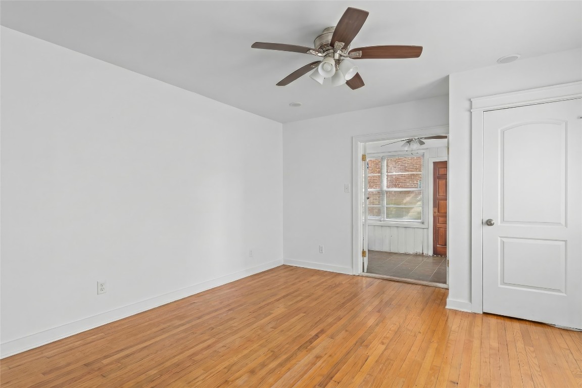 1740 Wroxton Court Houston, TX 77005 - Photo 8 of 27 an empty room with wooden floor and windows