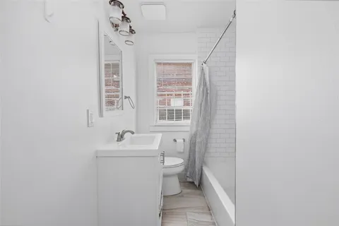 a bathroom with a sink mirror and toilet