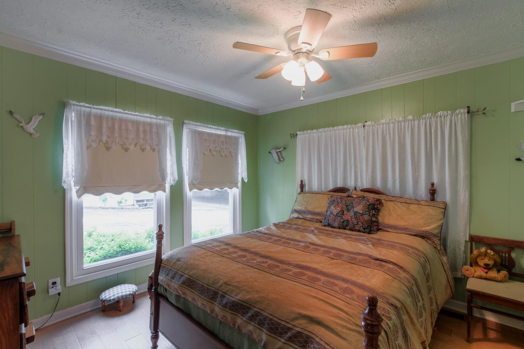 945 Turner Road Watertown, TN 37184 - Photo 17 of 30 a bedroom with a large bed and a chandelier