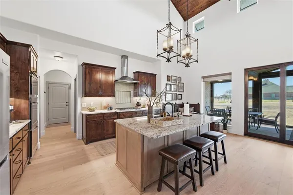 a large kitchen with a table and chairs
