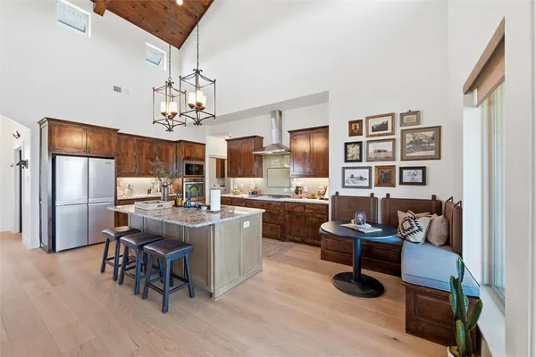 a view of a dining room with furniture a chandelier and wooden floor