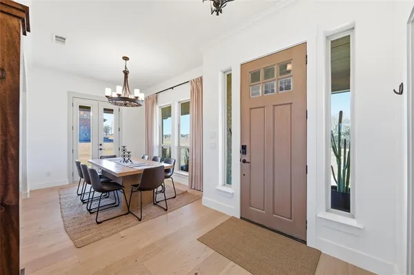 a view of a a dining room with furniture window and wooden floor