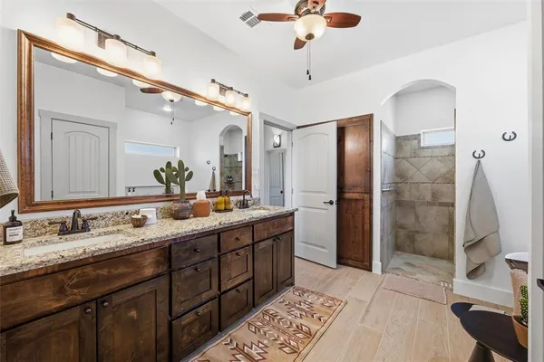 a bathroom with a double vanity sink mirror and shower