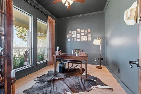 a view of a workspace with furniture and a window