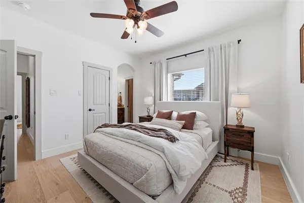 a bedroom with a bed and a chandelier