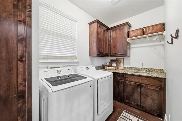 a kitchen with a stove sink and cabinets