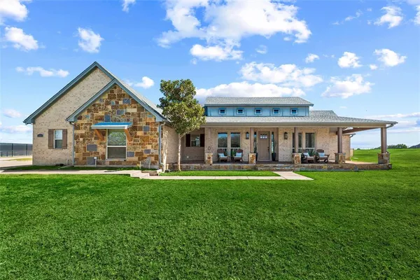 a front view of a house with swimming pool having outdoor seating
