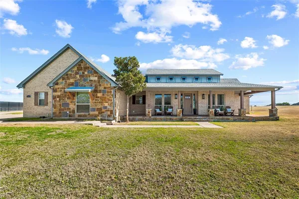 a front view of house with yard and outdoor seating