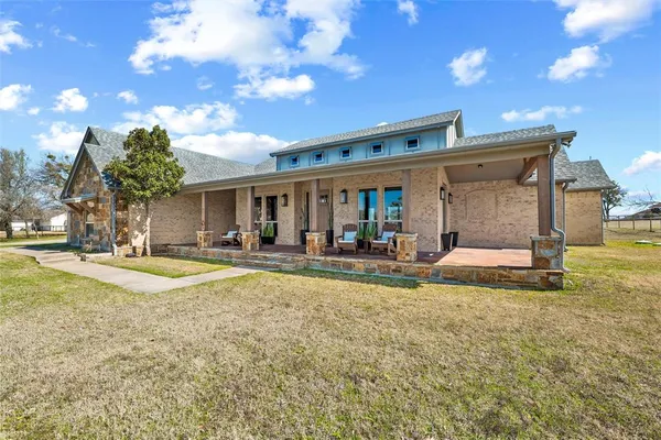 a view of a house with swimming pool and sitting area
