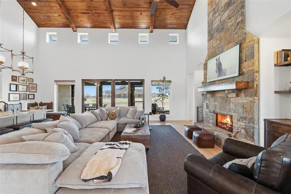 a living room with furniture a fireplace and a large window