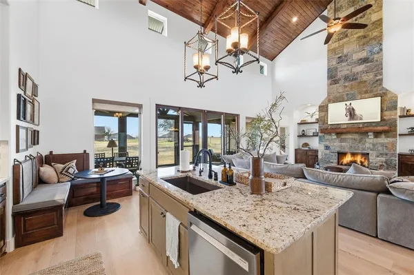 a kitchen with a counter top space a sink and cabinets