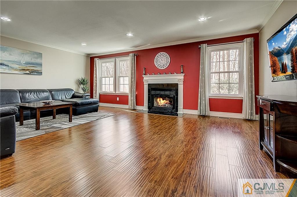 4505 Stonehedge Road Edison, NJ 08820 - Photo 2 of 25 a living room with furniture and a fireplace
