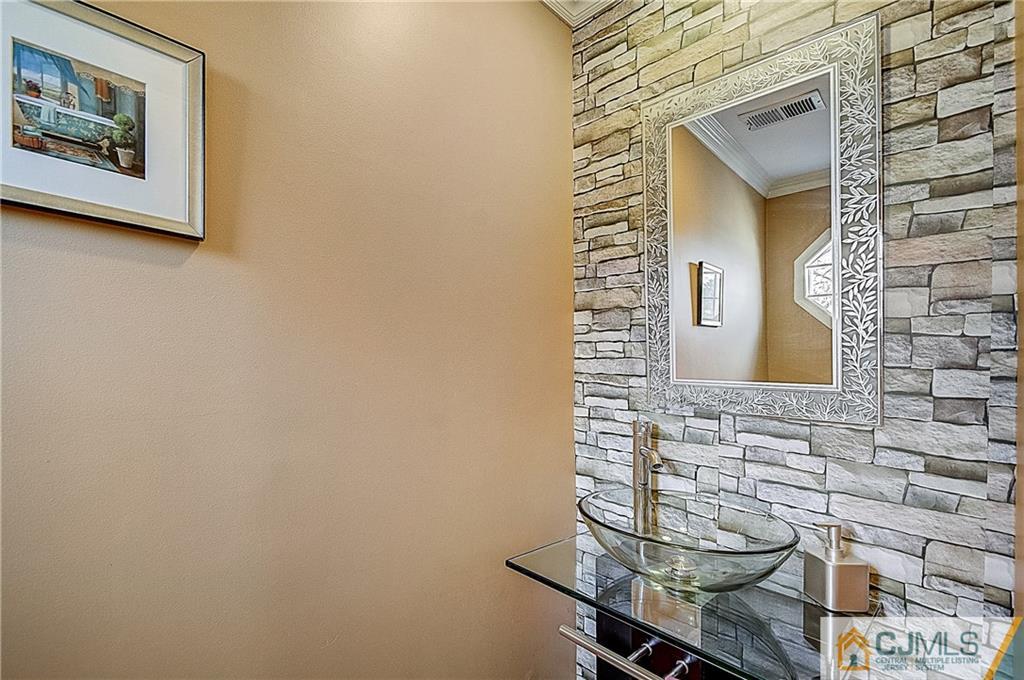 4505 Stonehedge Road Edison, NJ 08820 - Photo 11 of 25 a bathroom with a sink and a mirror