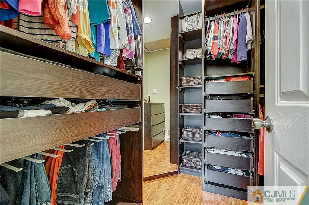 4505 Stonehedge Road Edison, NJ 08820 - Photo 15 of 25 a view of walk in closet with clothes and shoes