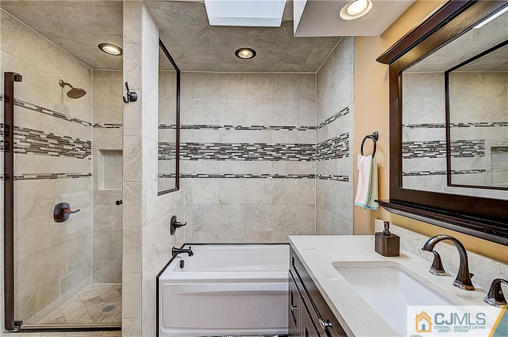 4505 Stonehedge Road Edison, NJ 08820 - Photo 16 of 25 a bathroom with a sink and a shower