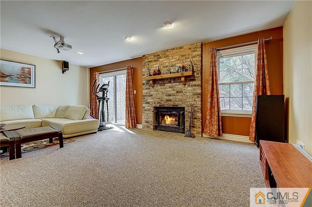 4505 Stonehedge Road Edison, NJ 08820 - Photo 20 of 25 a living room with furniture and a fireplace