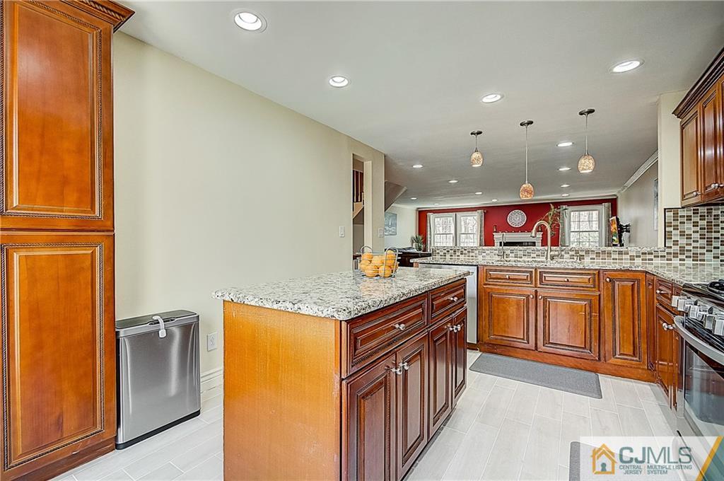 4505 Stonehedge Road Edison, NJ 08820 - Photo 10 of 25 a kitchen with stainless steel appliances granite countertop a stove a sink and a refrigerator