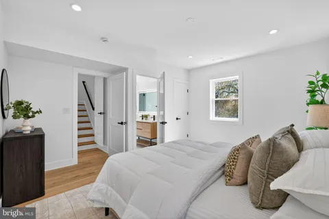 a spacious bedroom with a bed and a window