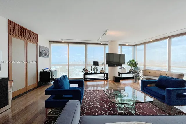 a living room with furniture and a flat screen tv