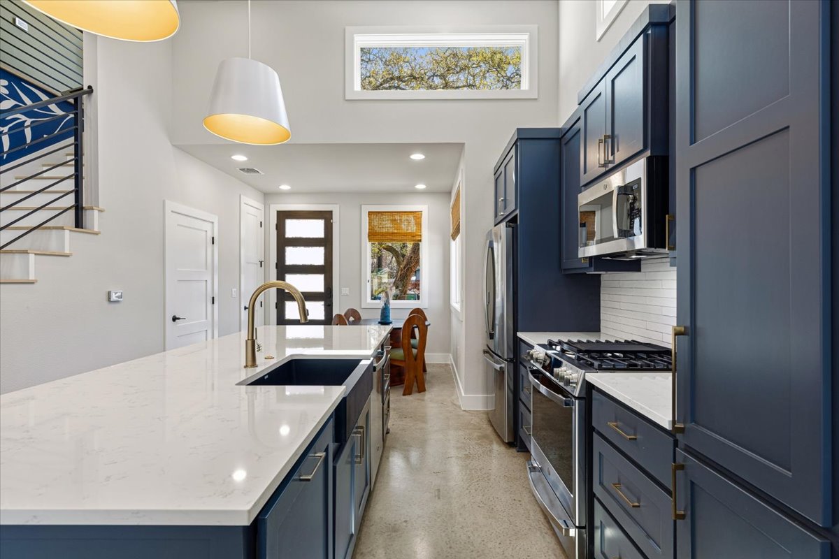 3602 Pennsylvania Avenue, Unit 2 Austin, TX 78721 - Photo 6 of 32 Rich blue cabinetry adds a bold design statement against quartz countertops.