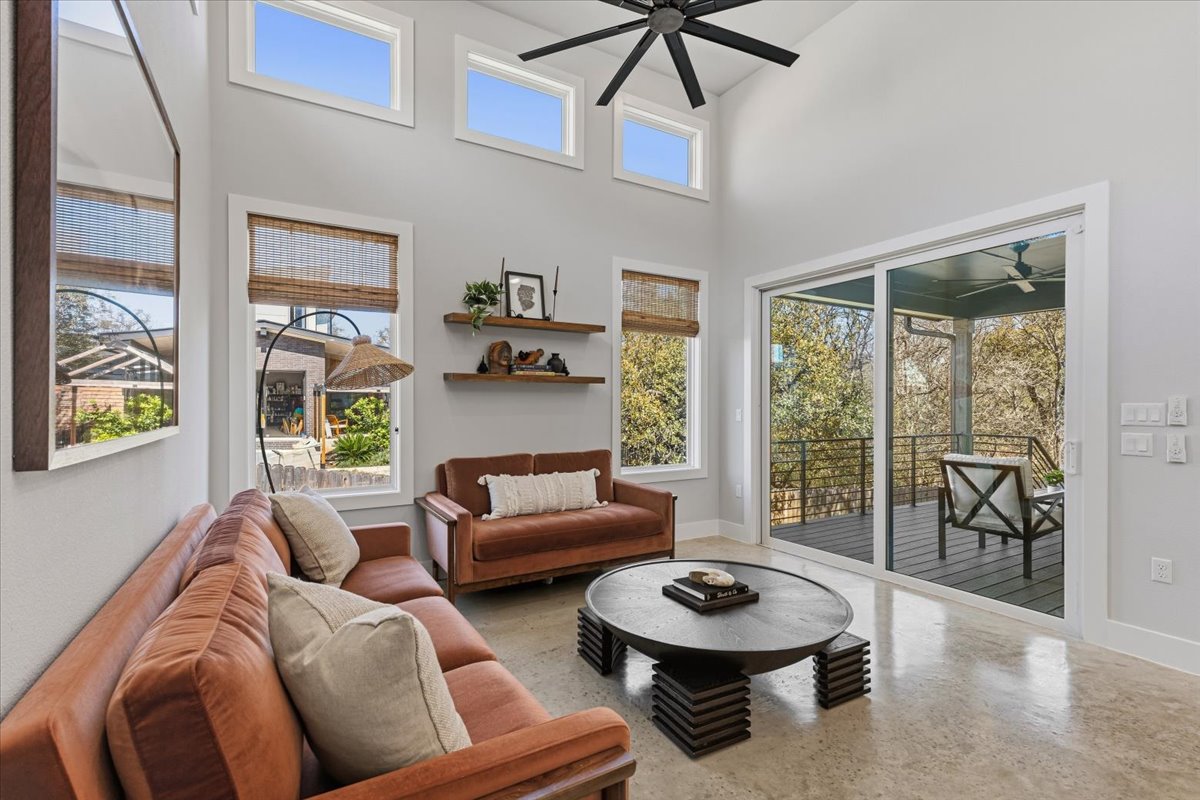 3602 Pennsylvania Avenue, Unit 2 Austin, TX 78721 - Photo 9 of 32 Sliding glass doors connect the living room to the covered deck and backyard.