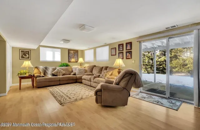 a living room with furniture and a floor to ceiling window